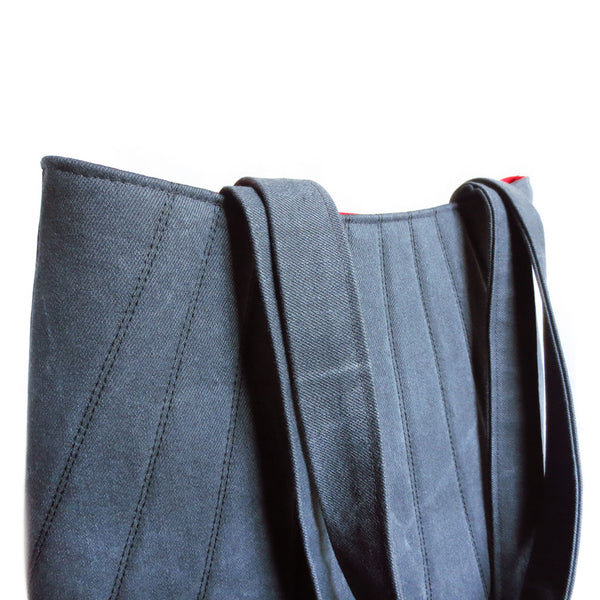 detail of the 517 tote from Holland Cox, showing its gently curving silhouette