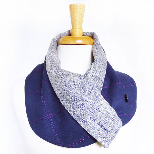 the button scarf styled with one button undone, and the lining folded over to be visible