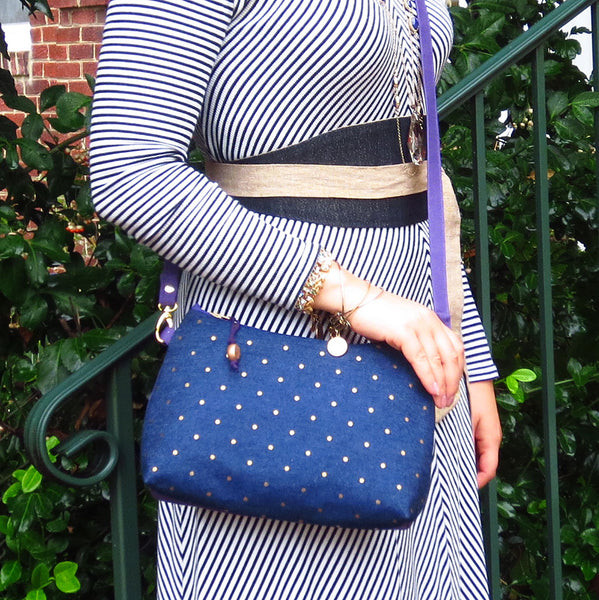the lola crossbody bag worn by Emily, who is also wearing the selina wrap belt