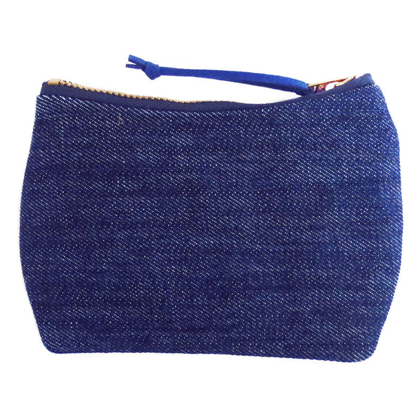 the back of the persephone mini pouch is dark blue denim