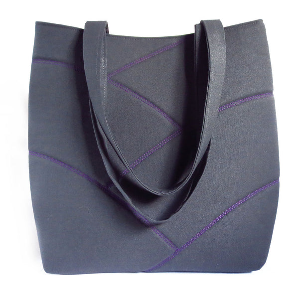 Dark gray and purple vegan tote bag, perfect for hauling books and papers to school or work in style. Purple stitching on gray, with bright purple back.