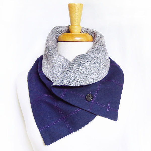 the anjelica button scarf with the curved edges folded over to create a collar