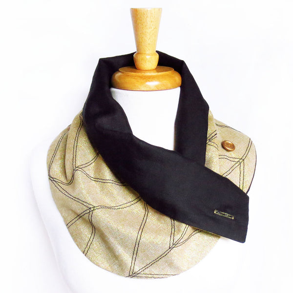 gold and black handmade scarf with one button undone