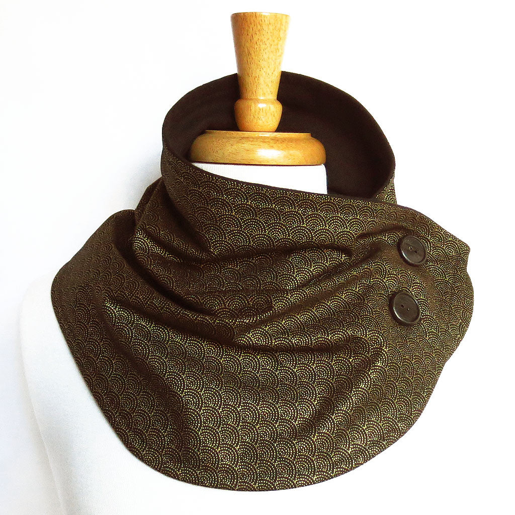 button scarf in a subtle black and gold scallop print, with hand painted black buttons and lined in black flannel