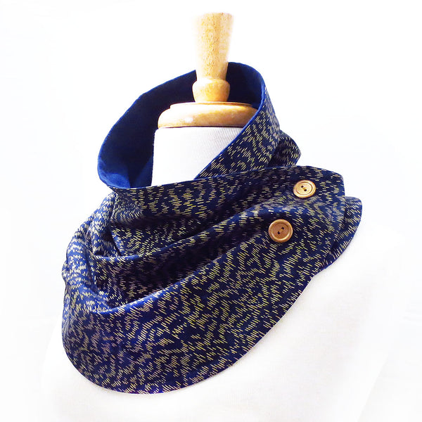 fabric button scarf in navy blue with small scale gold dash marks, buttoned with two hand painted gold buttons.