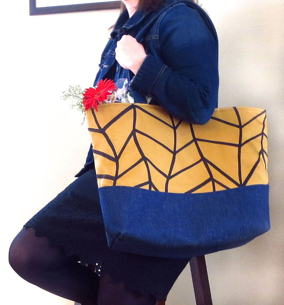 the Cassandra tote held by a model, showing its generous size