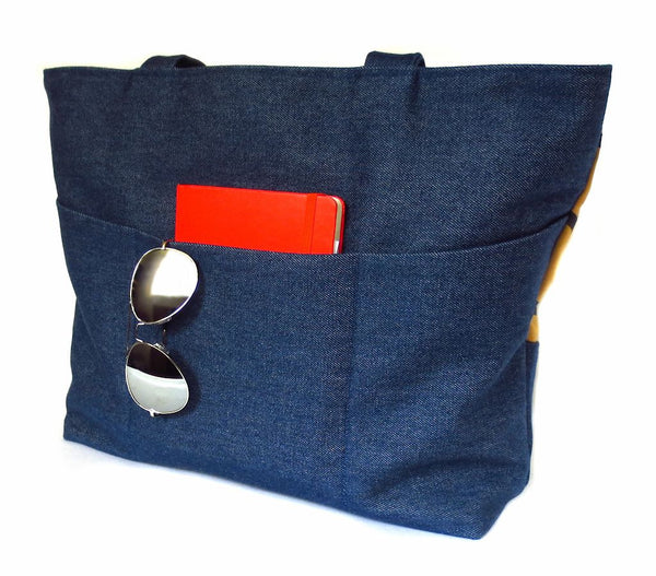 back view of the Cassandra tote, showing three deep pockets in dark blue denim