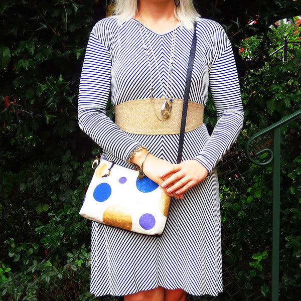 the felicity crossbody bag worn by a model to show it's size. model is also wearing the selina wrap belt