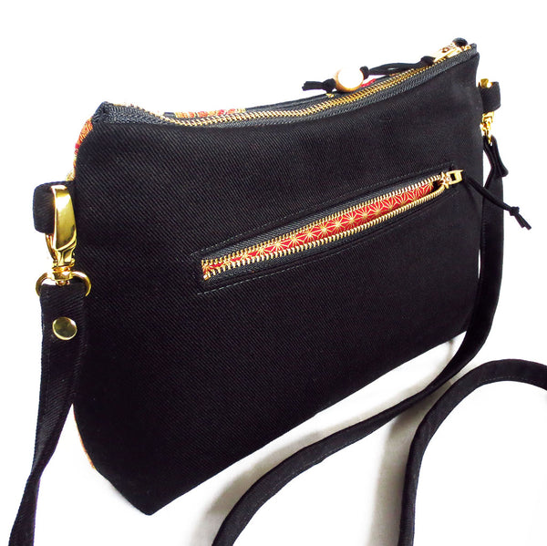 the back pocket on the crossbody bag is 7" wide and lined in a contrasting fabric
