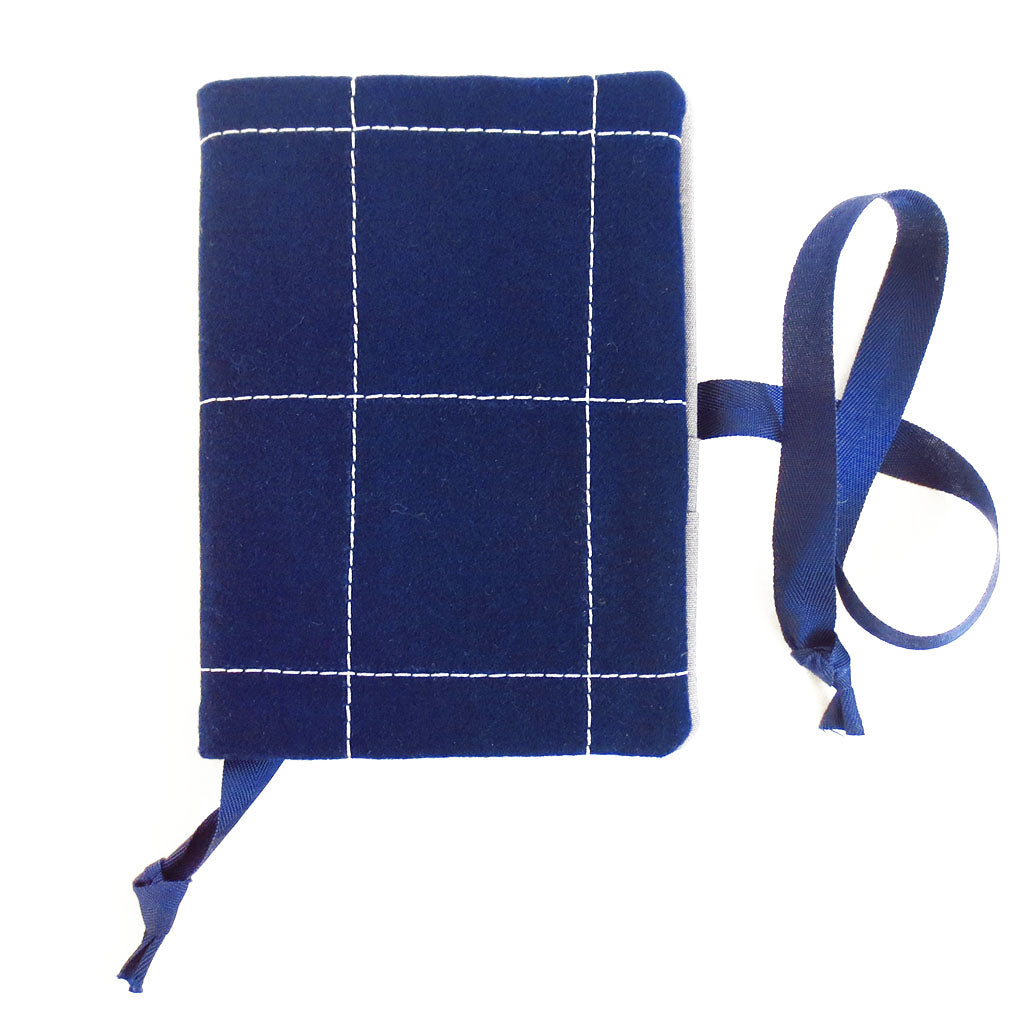 navy blue wool felt, stitched in large windowpane check in light gray thread.