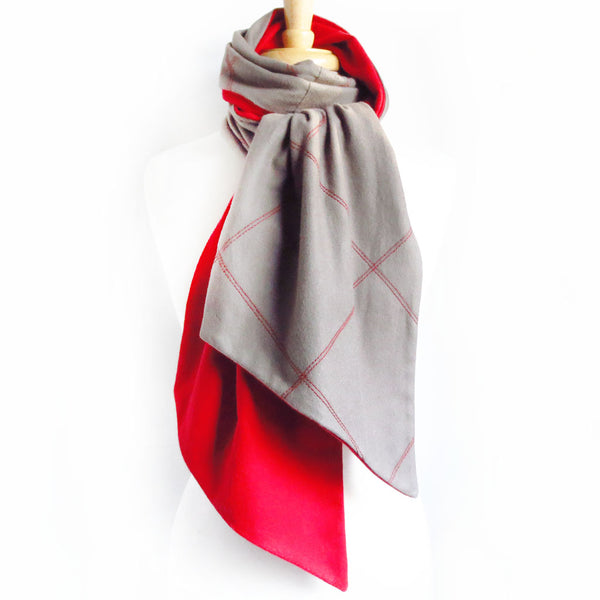 gray flannel scarf stitched with large scale windowpane check in red, and lined in red flannel. Wrapped and knotted around a dressform neck.