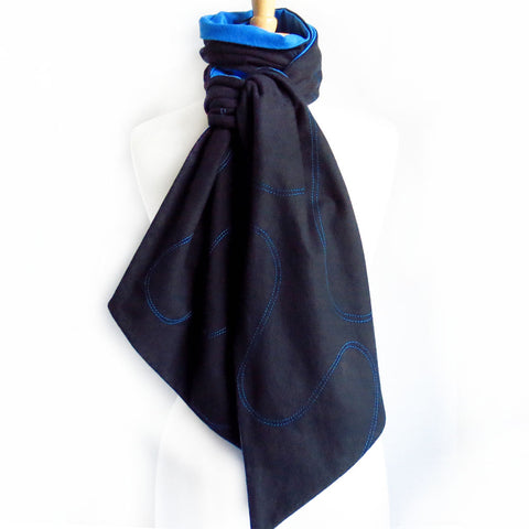 black flannel scarf with blue stitching and blue lining