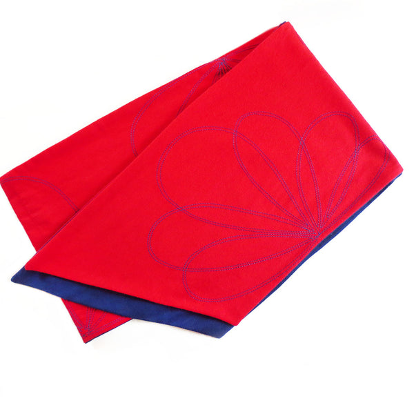 persephone scarf folded to show of navy lining, angled edges, and petal motif stitching
