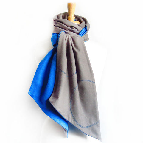 gray flannel scarf stitched with circle motif in bright blue, lined with blue flannel