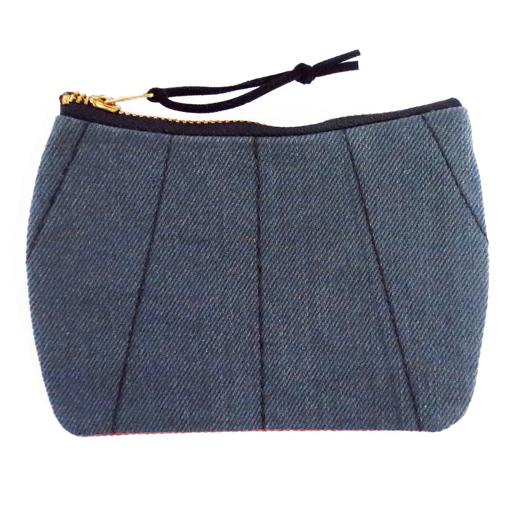 gray denim with black stitching on the front of the simone mini pouch