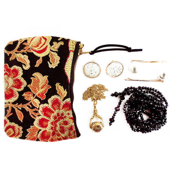 the phoenix mini pouch shown with a small set of jewelry that could easily fit inside - two necklaces, a set of earrings, and a pair of pearl hair pins