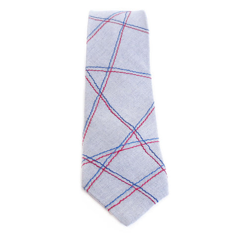 Handmade cotton blend necktie in light gray, stitched with abstract linear pattern in red and blue. 
