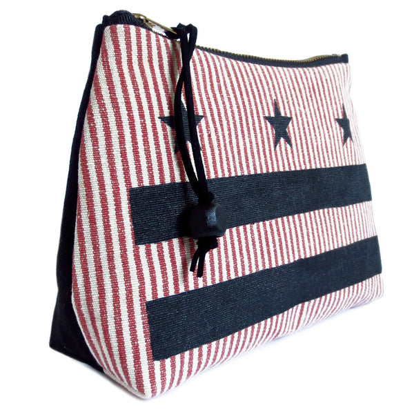 zipper pouch featuring the Washington DC flag stenciled in black 