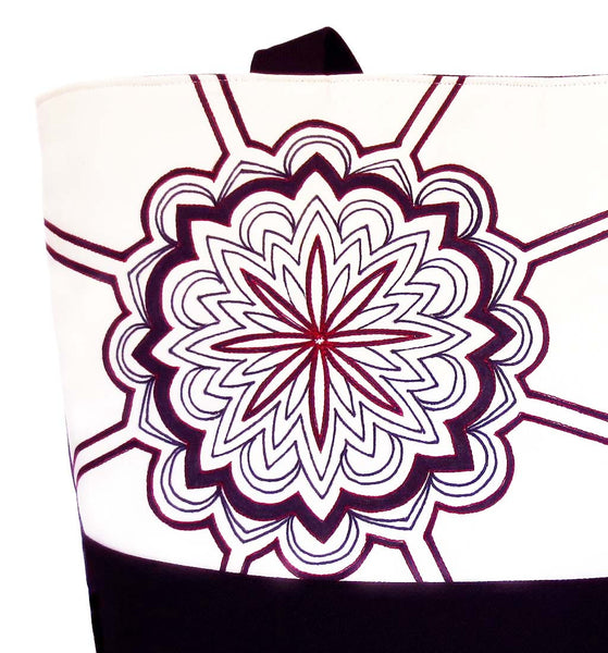 close up of the hand drawn mandala stitched with red on the regina tote from Holland Cox