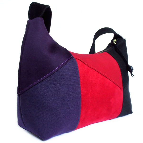 side view of the trinity everyday bag, showing the purple side