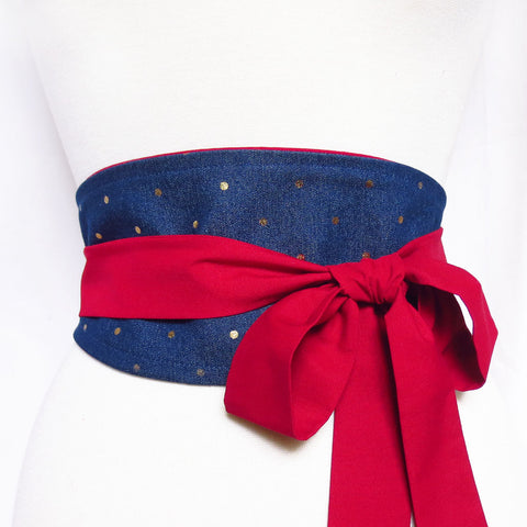 denim obi-style belt with metallic gold polka dots and long red ties, wrapped and tied in a bow off to one side