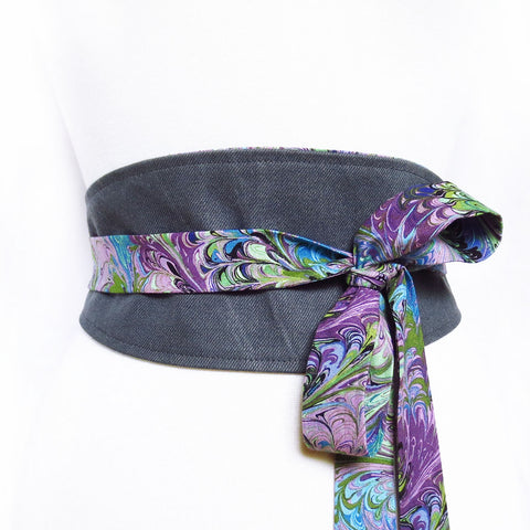 dark gray denim obi style belt with long ties in purple book marble print; tied off to one side in a loose bow