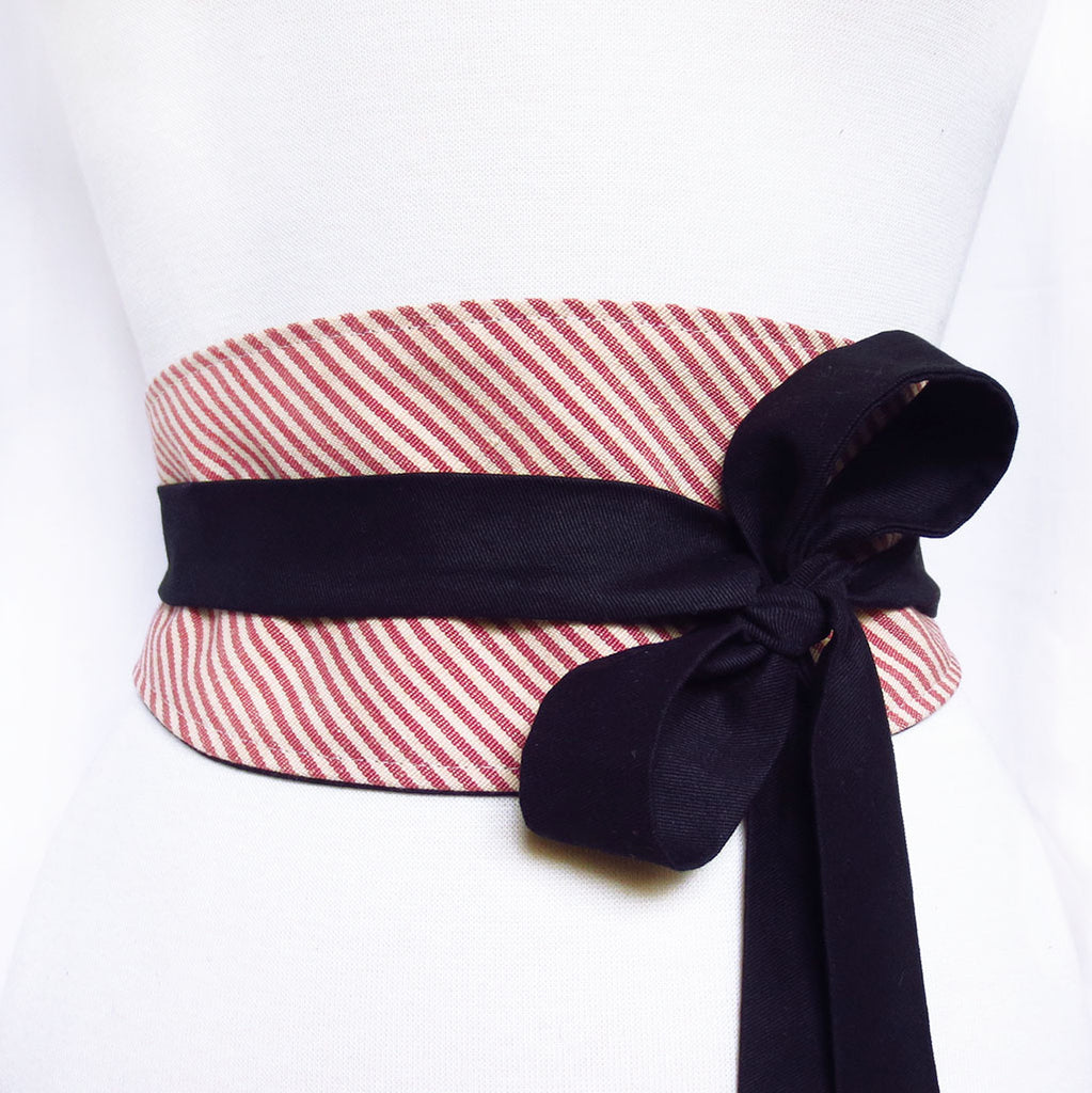 obi style belt made from red and white striped mattress ticking. Long ties are black cotton, wrapped and tied in a loose bow off to one side